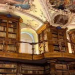 Interior of the Abbey Library of St Gallen with ornate wooden shelves and ceiling
