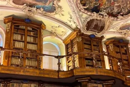 Interior of the Abbey Library of St Gallen with ornate wooden shelves and ceiling