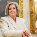 Susie Wiles standing beside President Donald Trump after announcing her breast cancer diagnosis.