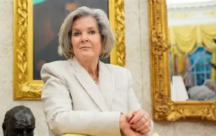 Susie Wiles standing beside President Donald Trump after announcing her breast cancer diagnosis.