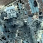 Tehran skyline at night with smoke rising after airstrikes