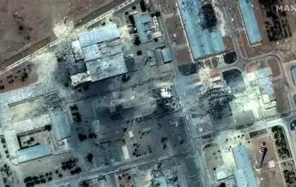 Tehran skyline at night with smoke rising after airstrikes