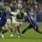France rugby players celebrating a Six Nations victory after a tough tournament.