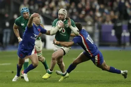 France rugby players celebrating a Six Nations victory after a tough tournament.