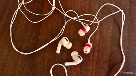 Person listening to music using wired headphones connected to a smartphone.