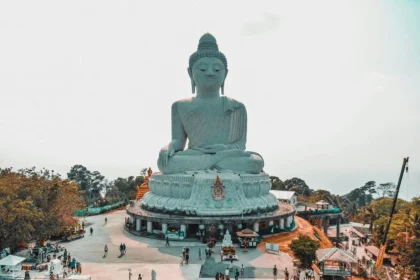 Dark side of luxury travel tourism at large Buddha statue Phuket Thailand