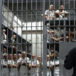 Exploring the world’s most notorious prisons dark corridor with iron bars