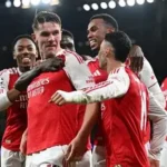 Arsenal players celebrating Champions League semi-final qualification under Mikel Arteta