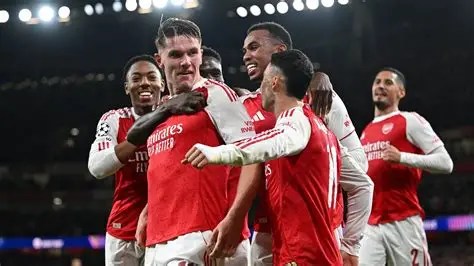 Arsenal players celebrating Champions League semi-final qualification under Mikel Arteta