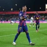 Barcelona's Raphinha gestures angrily post-match after Champions League defeat to Atletico Madrid amid referee controversy.