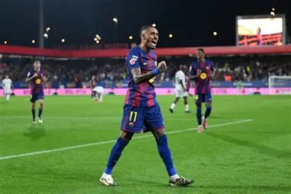 Barcelona's Raphinha gestures angrily post-match after Champions League defeat to Atletico Madrid amid referee controversy.