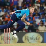 England bowler Brydon Carse grimaces holding injured right bowling hand during training session.