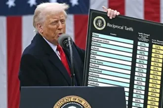Trading floor screens display surging tariffs and shifting global trade routes one year after Trump's Liberation Day announcement.