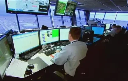 Air traffic controller managing flights with radar screens, inspired by gaming skills