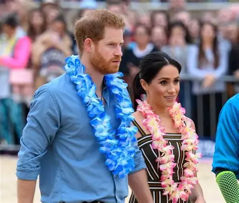 Prince Harry and Meghan Markle pose for selfie with Bondi lifeguards at Surf Bathers' Life Saving Club during survivors meeting.