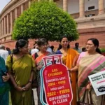 Women form human chain supporting Prime Minister Narendra Modi's women's reservation bill during public rally.
