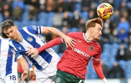 John Terry watches from Colchester United stands during League Two match against Accrington, amid takeover rumors.