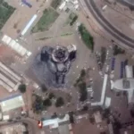 Mohamed Suleiman, emaciated Sudanese journalist, holds phone displaying backlog of war death messages after escaping el-Fasher RSF siege.