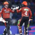 Sunrisers Hyderabad players celebrate their 65-run IPL victory over KKR at Eden Gardens, with fans cheering in the background.