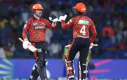 Sunrisers Hyderabad players celebrate their 65-run IPL victory over KKR at Eden Gardens, with fans cheering in the background.