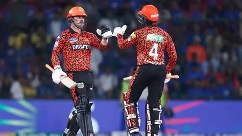 Sunrisers Hyderabad players celebrate their 65-run IPL victory over KKR at Eden Gardens, with fans cheering in the background.
