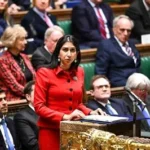 Undercover investigator meets immigration lawyer in London office discussing £7K fake gay asylum package with fabricated evidence documents.