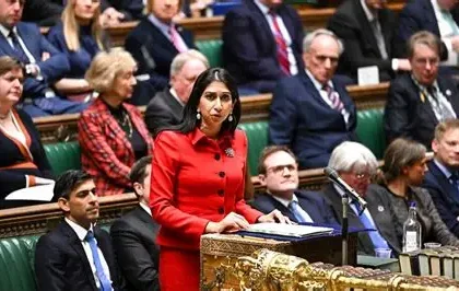 Undercover investigator meets immigration lawyer in London office discussing £7K fake gay asylum package with fabricated evidence documents.