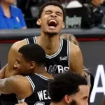 Victor Wembanyama celebrating NBA Defensive Player of the Year award