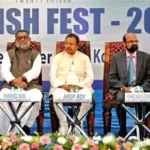 BJP candidate Rakesh Singh holds a large fish high during his West Bengal election campaign in Kolkata.