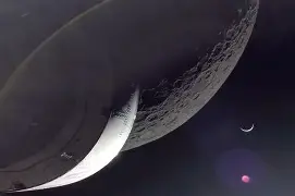 Artemis II astronaut Reid Wiseman photographs Earth and Moon from Orion spacecraft window 142,000 miles from home, capturing auroras and Venus.