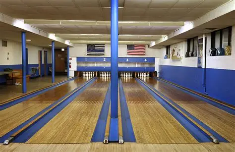 Bowlers compete in dimly lit basement alley under Immaculate Conception Catholic School Chicago