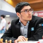 Alireza Firouzja lies on bed playing chess during 2026 Superbet Chess Classic Romania