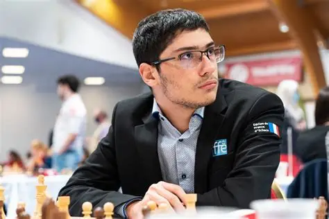 Alireza Firouzja lies on bed playing chess during 2026 Superbet Chess Classic Romania