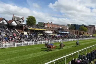 Jockeys and officials inspecting Chester racecourse after unsafe ground caused race delay