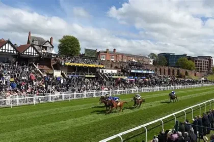 Jockeys and officials inspecting Chester racecourse after unsafe ground caused race delay