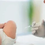 Doctor preparing vitamin K shot for newborn baby in hospital