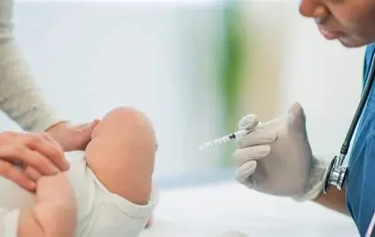 Doctor preparing vitamin K shot for newborn baby in hospital