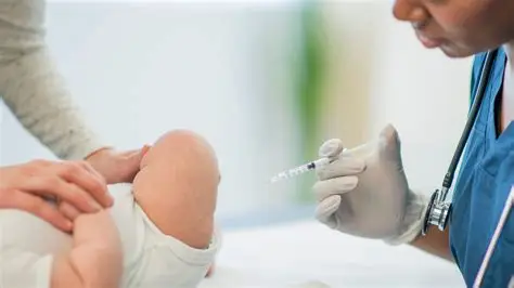 Doctor preparing vitamin K shot for newborn baby in hospital