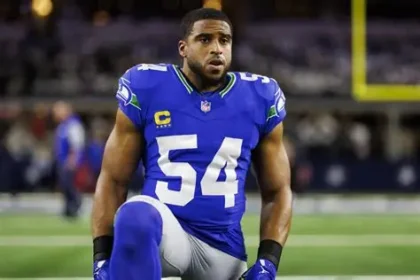 Bobby Wagner receives honorary doctorate on stage at Utah State University commencement.