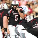Former South Carolina Gamecocks quarterback Stephen Garcia in uniform on the sideline during a college football game, looking focused before taking the field.