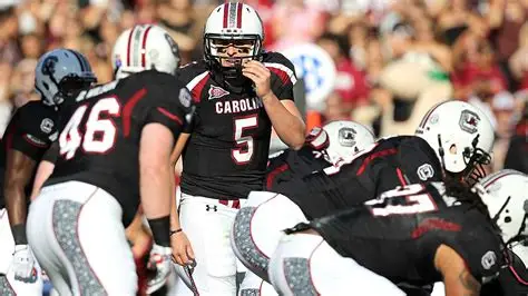 Former South Carolina Gamecocks quarterback Stephen Garcia in uniform on the sideline during a college football game, looking focused before taking the field.