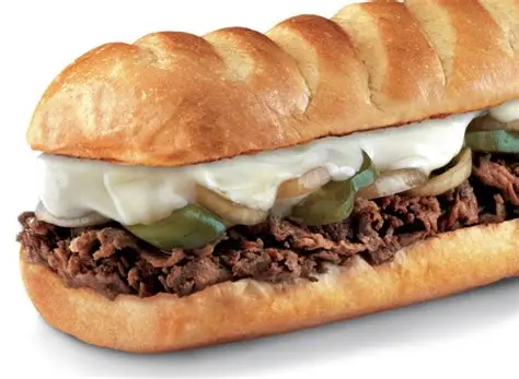 Medium Firehouse Subs Steak & Cheese Melt with prime rib, provolone, caramelized onions on top-cut roll.