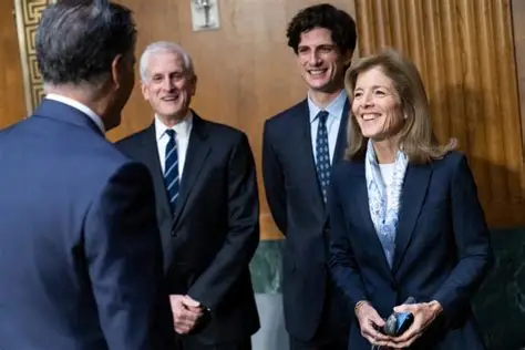 Jack Schlossberg and Caroline Kennedy pose outside a deli on Manhattan’s Upper West Side after a bagel stop.