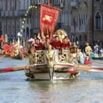 Vibrant Venice Carnival crowd in masks and costumes on Rialto Bridge.