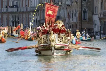 Vibrant Venice Carnival crowd in masks and costumes on Rialto Bridge.