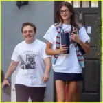 Kaia Gerber and Jake Shane carrying matching burgundy Chanel Maxi Flap bags in Beverly Hills