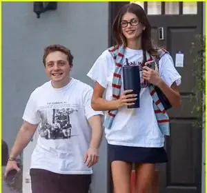Kaia Gerber and Jake Shane carrying matching burgundy Chanel Maxi Flap bags in Beverly Hills
