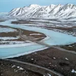 Alaska lawmakers debate trans-Alaska gas pipeline subsidy with project model on table.