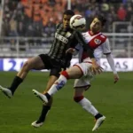 Rayo Vallecano players celebrate crisp win at Valencia's Mestalla stadium under floodlights