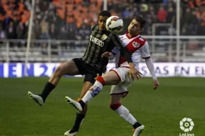Rayo Vallecano players celebrate crisp win at Valencia's Mestalla stadium under floodlights